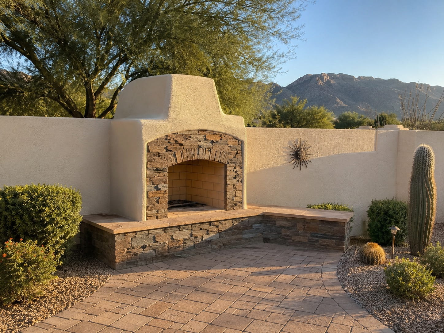 Adobe-style outdoor fireplace with mountain views at a Tucson home